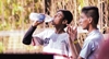 Children take a break as they drink water to quench their thirst at Shivaji Park 
