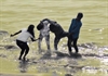 Youngsters splash water on each other at the beach